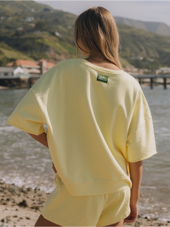 Daily Drills Tops - ⭐️Daily Drills Light Yellow Sweatshirt with Green Logo Patch